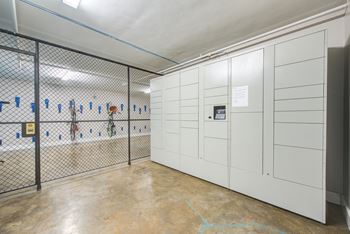 a room with white lockers and a chain link fence